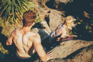 people climbing down a rock